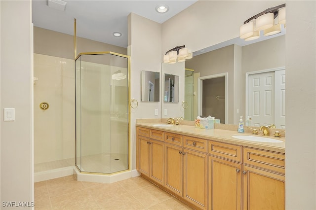 bathroom with walk in shower, vanity, and tile patterned flooring