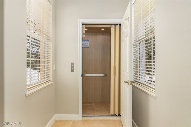 hallway featuring light tile patterned floors