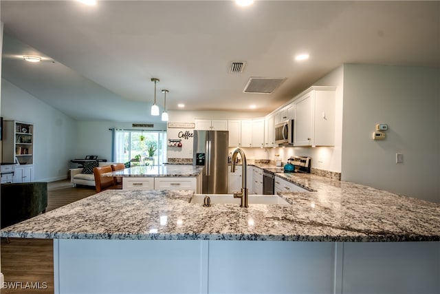 kitchen with pendant lighting, dark hardwood / wood-style floors, white cabinetry, kitchen peninsula, and appliances with stainless steel finishes