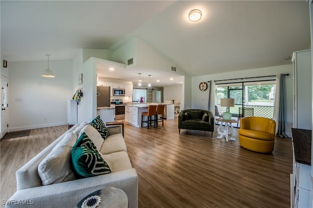 living room featuring high vaulted ceiling and wood-type flooring