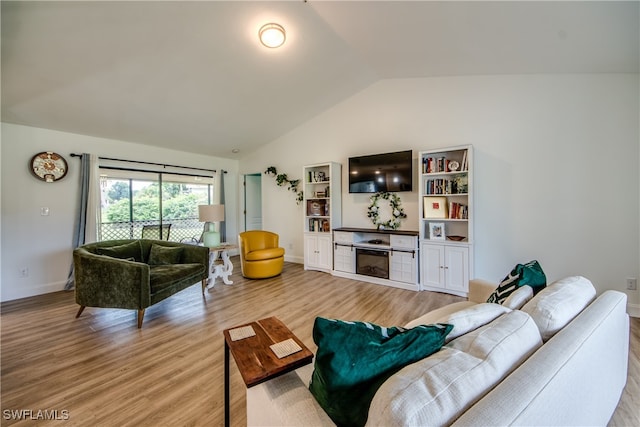 living room featuring light hardwood / wood-style floors and vaulted ceiling