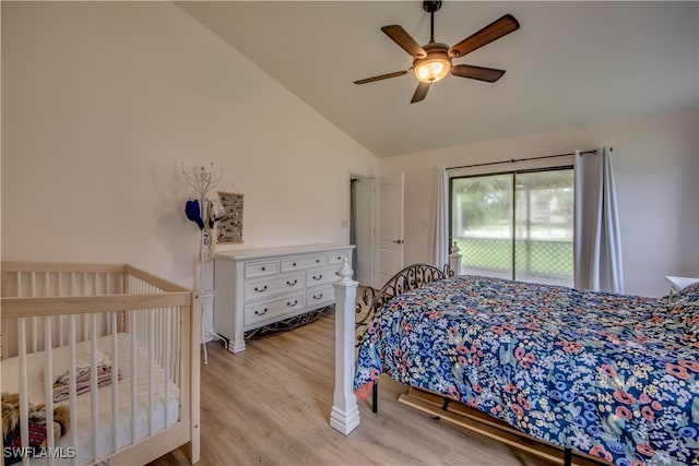 bedroom with light hardwood / wood-style floors, vaulted ceiling, and ceiling fan