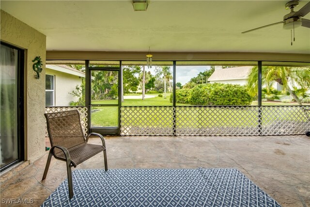 sunroom featuring ceiling fan