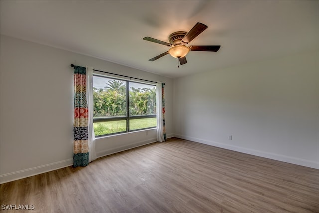 spare room with light wood-type flooring and ceiling fan