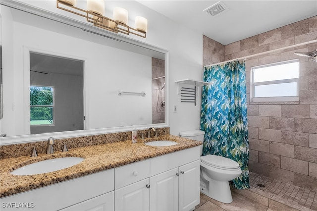 1905 SW 11th St, Cape Coral, FL 33991 - full bathroom with toilet, a tile shower, healthy amount of natural light, and double vanity