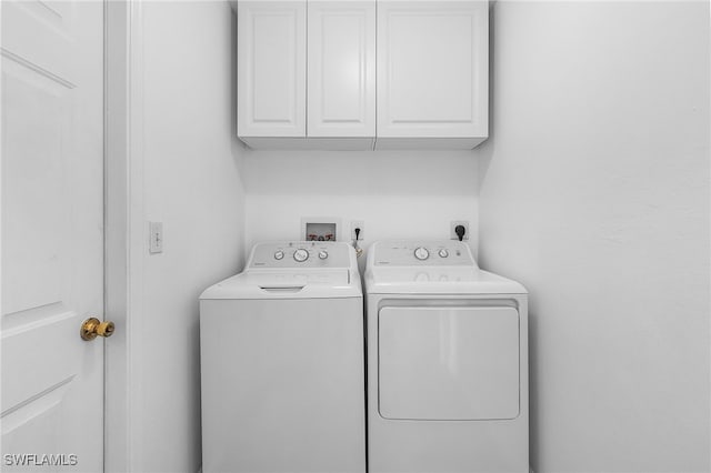 laundry room featuring cabinets and independent washer and dryer