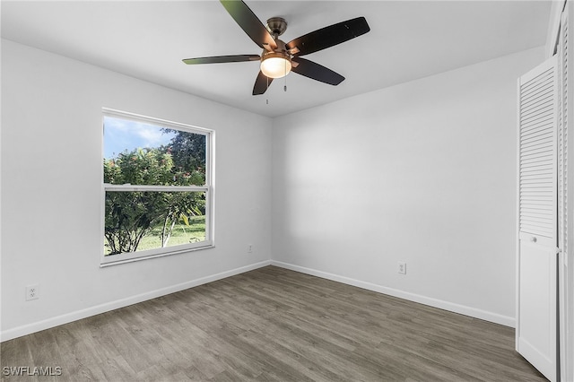 unfurnished bedroom featuring a closet, ceiling fan, and dark hardwood / wood-style flooring