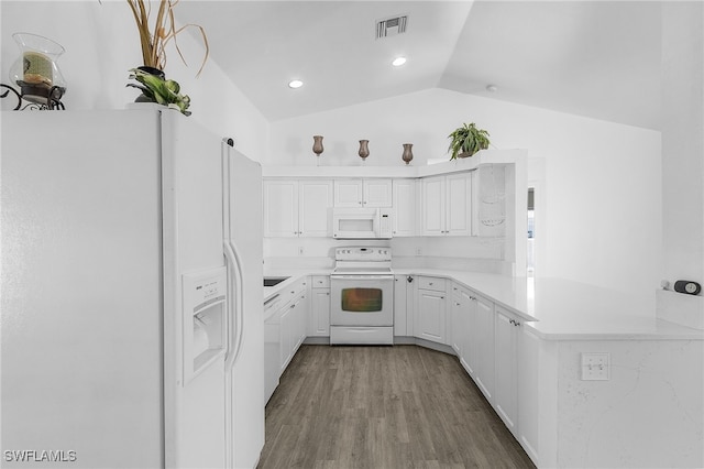 1905 SW 11th St, Cape Coral, FL 33991 - kitchen with white appliances, vaulted ceiling, light countertops, a peninsula, and white cabinetry