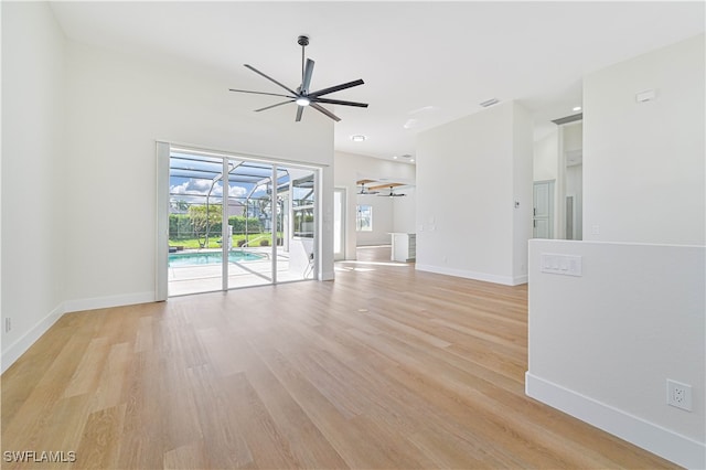 unfurnished living room featuring light wood-type flooring and ceiling fan