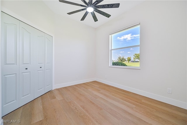 unfurnished bedroom featuring ceiling fan, light hardwood / wood-style flooring, and a closet