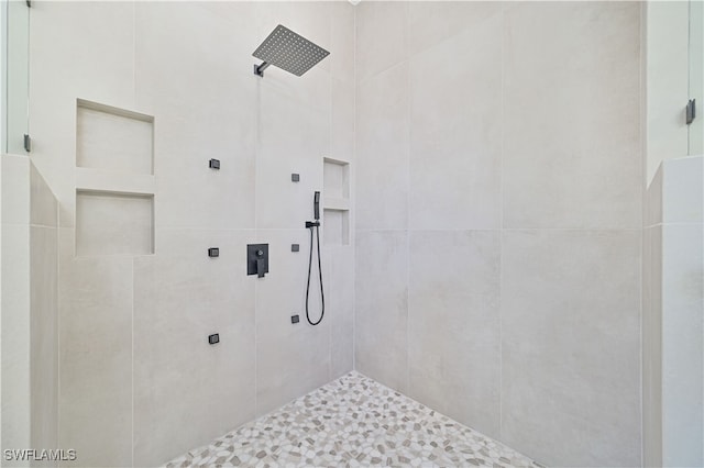 bathroom with tiled shower