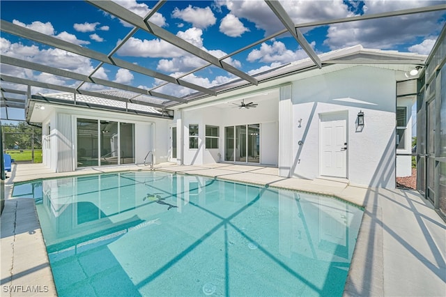 view of pool with a patio, a lanai, and ceiling fan