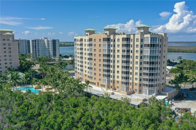 view of property featuring a water view and a community pool