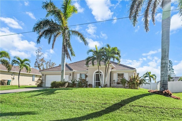 view of front of property featuring a garage and a front yard