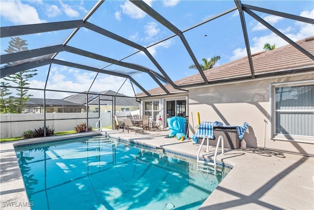 view of pool featuring a patio and glass enclosure