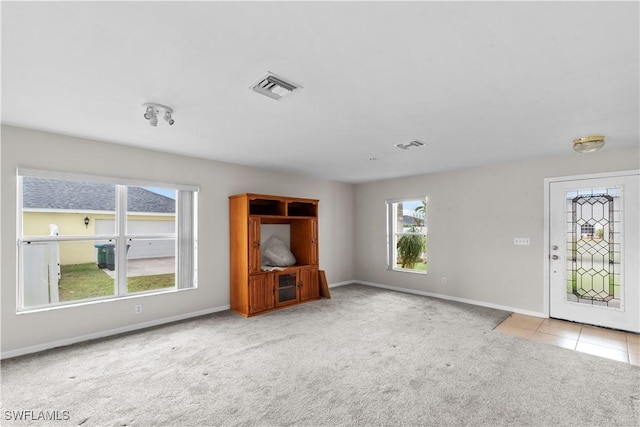 unfurnished living room featuring light colored carpet