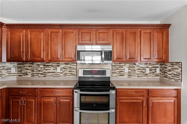 kitchen featuring stainless steel appliances and tasteful backsplash