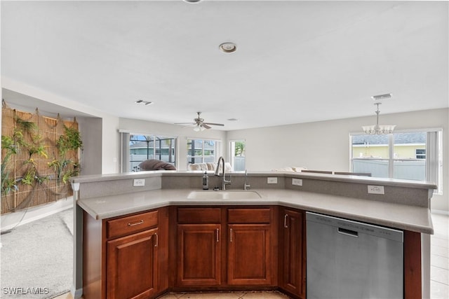 kitchen with pendant lighting, sink, ceiling fan with notable chandelier, and stainless steel dishwasher