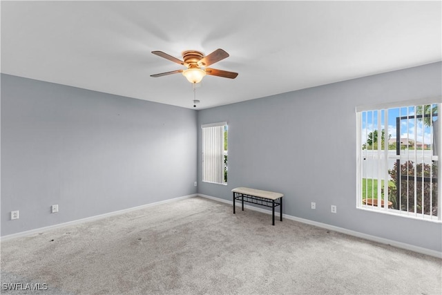 spare room with ceiling fan and carpet flooring