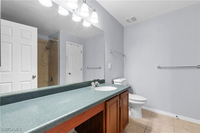 bathroom featuring vanity, tile patterned floors, and toilet