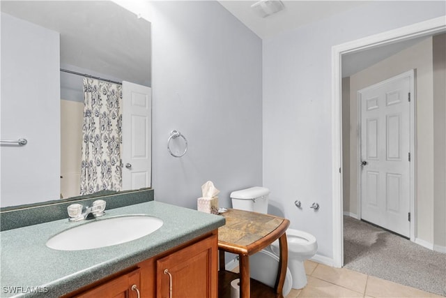 bathroom with tile patterned flooring, vanity, curtained shower, and toilet