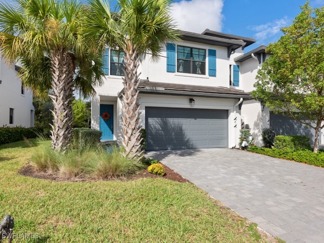 view of front facade with a garage and a front lawn