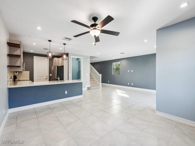 interior space with sink and ceiling fan