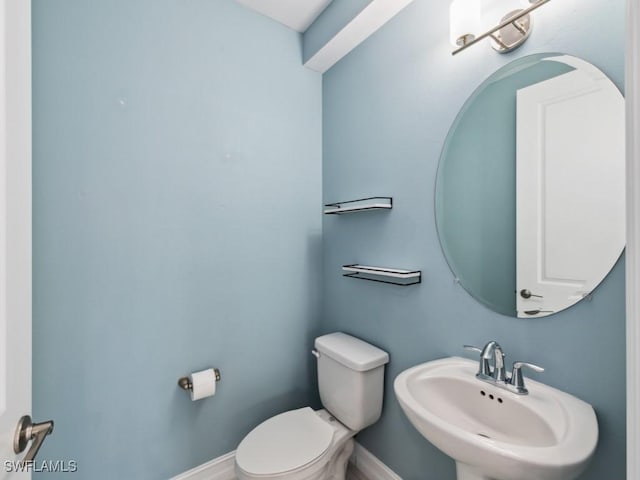 bathroom featuring sink and toilet