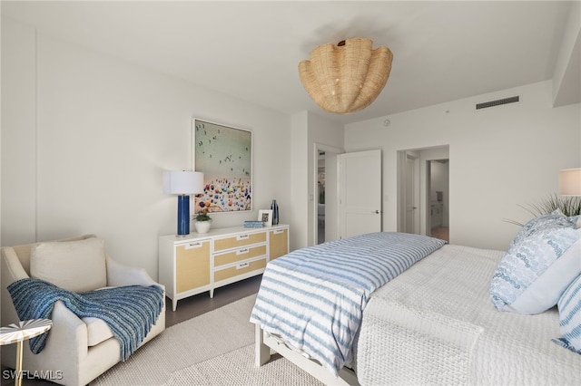 bedroom with visible vents and wood finished floors