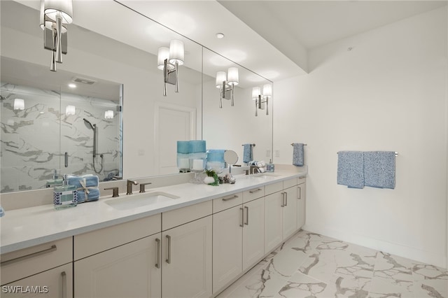 bathroom with double vanity, marble finish floor, a marble finish shower, and a sink