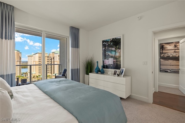 carpeted bedroom featuring access to exterior and baseboards