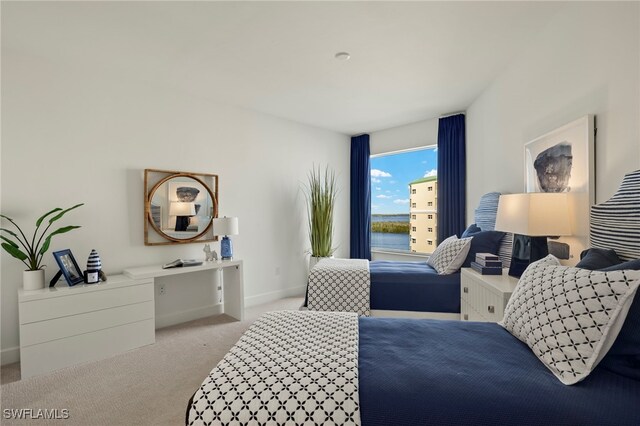 carpeted bedroom featuring baseboards