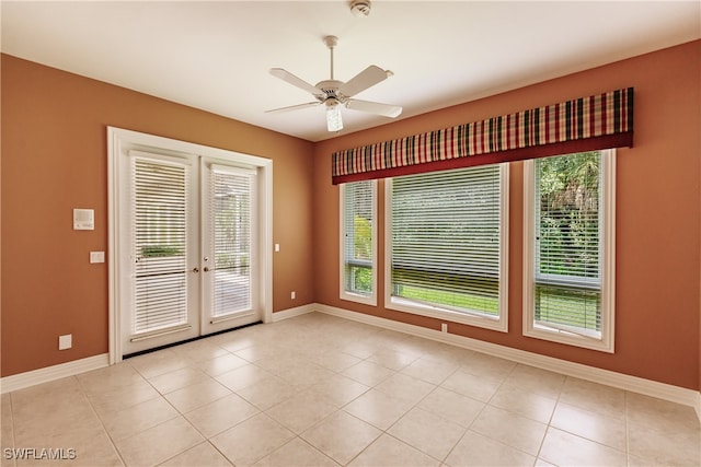 unfurnished room with light tile patterned flooring, ceiling fan, and french doors