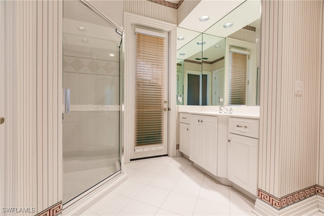 bathroom featuring walk in shower, vanity, and tile patterned floors