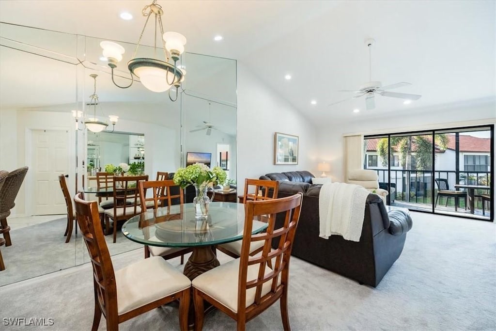 dining area with ceiling fan with notable chandelier, high vaulted ceiling, light carpet, and recessed lighting