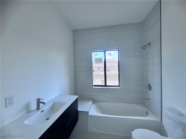 full bathroom featuring vanity, toilet, and tiled shower / bath combo