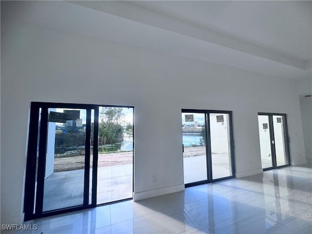 interior space featuring a water view and french doors