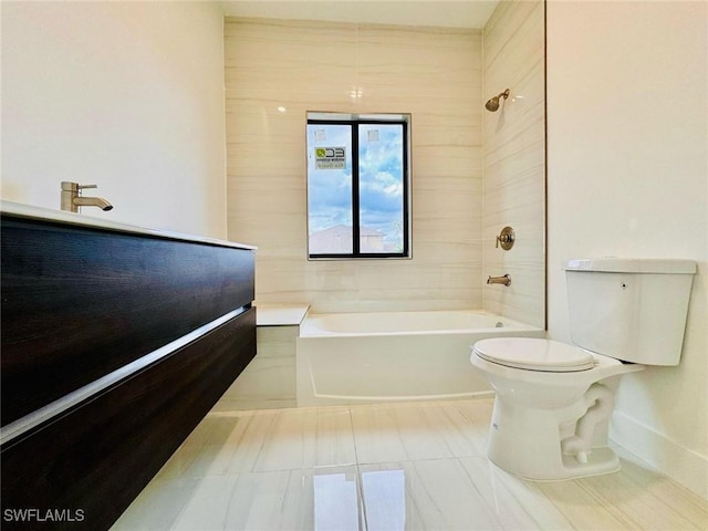 bathroom featuring tile patterned flooring, bathtub / shower combination, and toilet