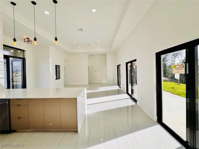 kitchen with recessed lighting, a raised ceiling, visible vents, and pendant lighting