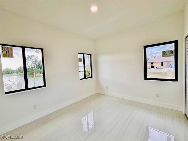 spare room featuring baseboards