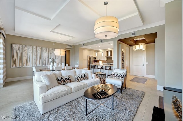 living room featuring a raised ceiling