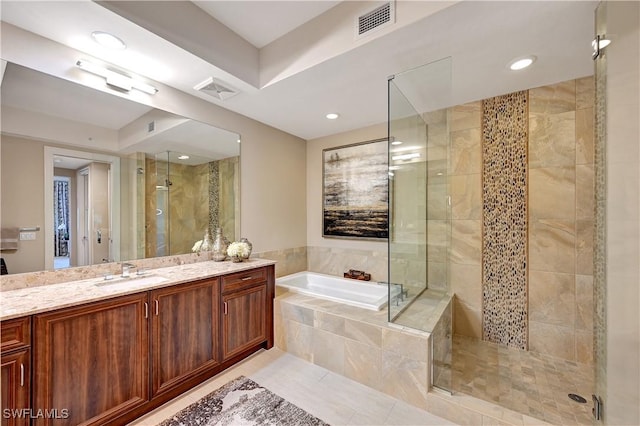 bathroom with tile patterned flooring, vanity, and separate shower and tub