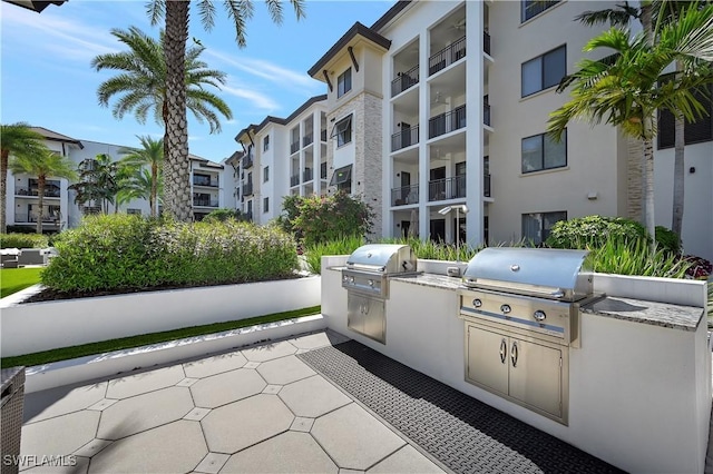 view of patio with exterior kitchen and grilling area