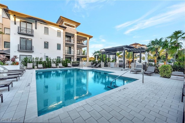 view of swimming pool with a pergola, grilling area, and a patio area