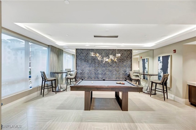 game room with a tray ceiling and billiards