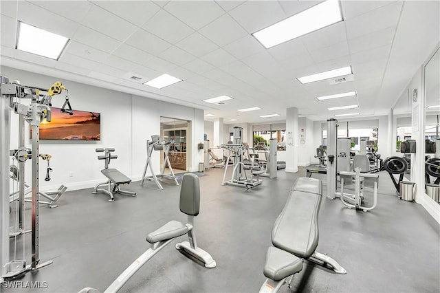 exercise room featuring a wealth of natural light and a drop ceiling