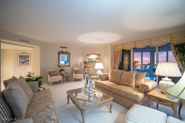 living room featuring crown molding and light carpet