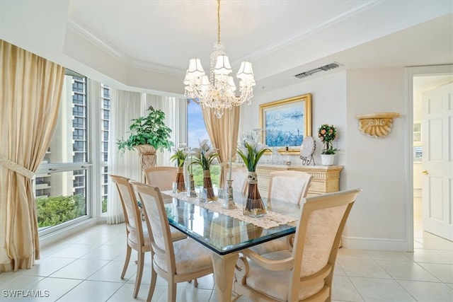 dining space with ornamental molding, light tile patterned floors, plenty of natural light, and an inviting chandelier