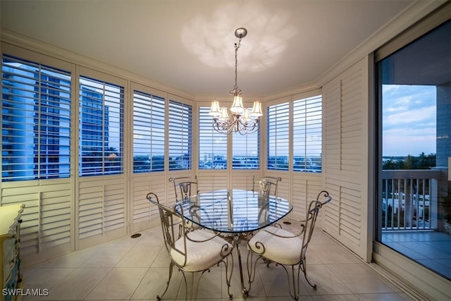 dining space with a notable chandelier, ornamental molding, light tile patterned flooring, and plenty of natural light