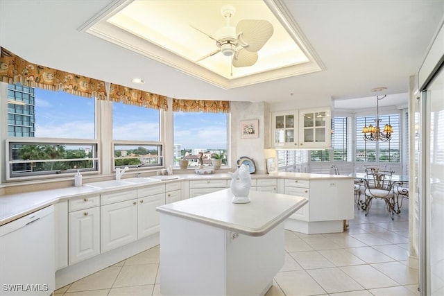 kitchen featuring a wealth of natural light, a kitchen island, white cabinetry, and dishwasher